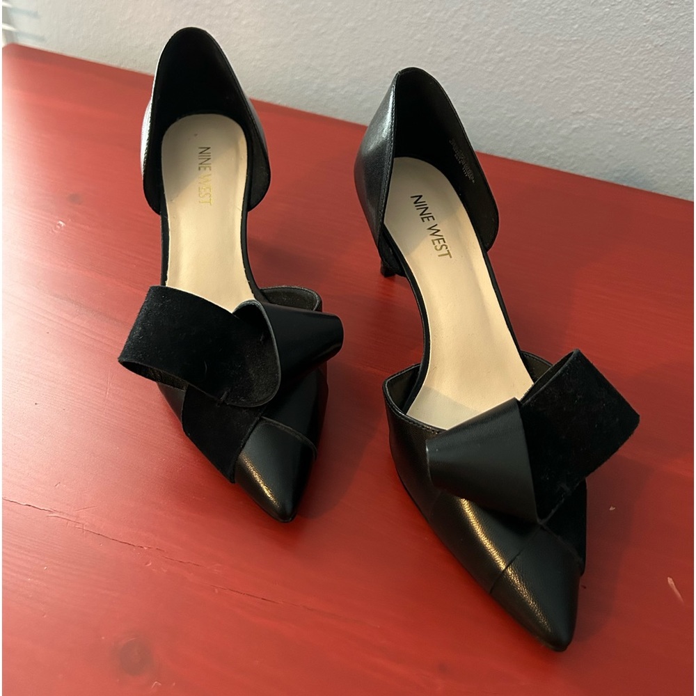 Kitty heel pumps with the cutest curls on top. They’ve only been worn once!